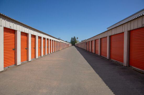 Service representative in front of the orange storage containers